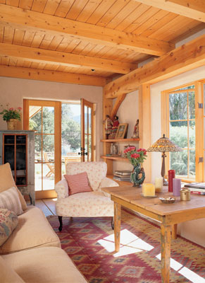 
When it comes to furnishings, Daryl’s style is natural and eclectic. Wood tables and chairs are antique or recycled. “I haven’t refinished any of them,” she says. Upholstered pieces are custom-made with organic stuffings and coverings. Daryl has had the handwoven all-cotton rug in each of her houses. Living room, dining room, and kitchen comprise one open sixteen-by-twenty-foot room.
